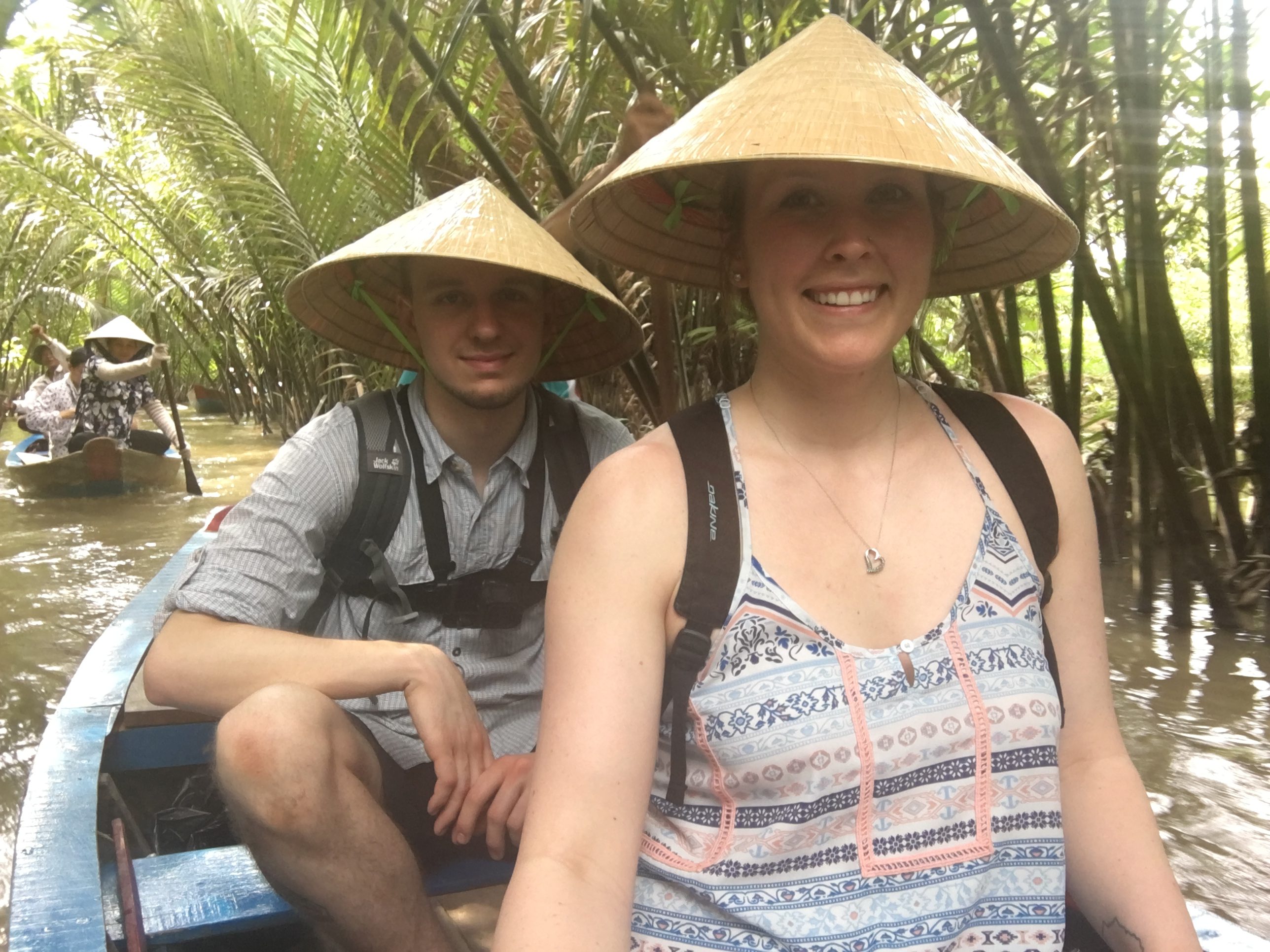 Ben and Erinn riding a boat through the canals of the Mekong Delta.
