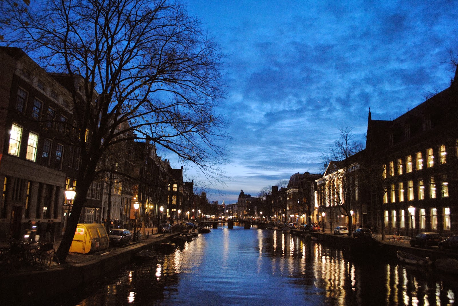 A night-time view of a canal in Amsterdam.