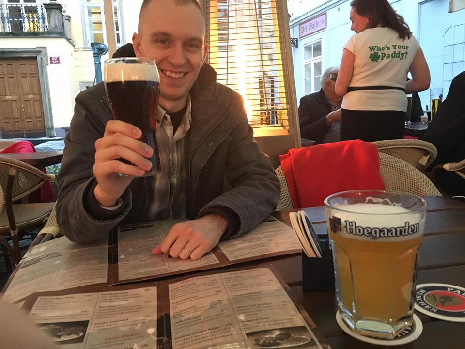 Ben holding a beer at The Dubliner in Prague.