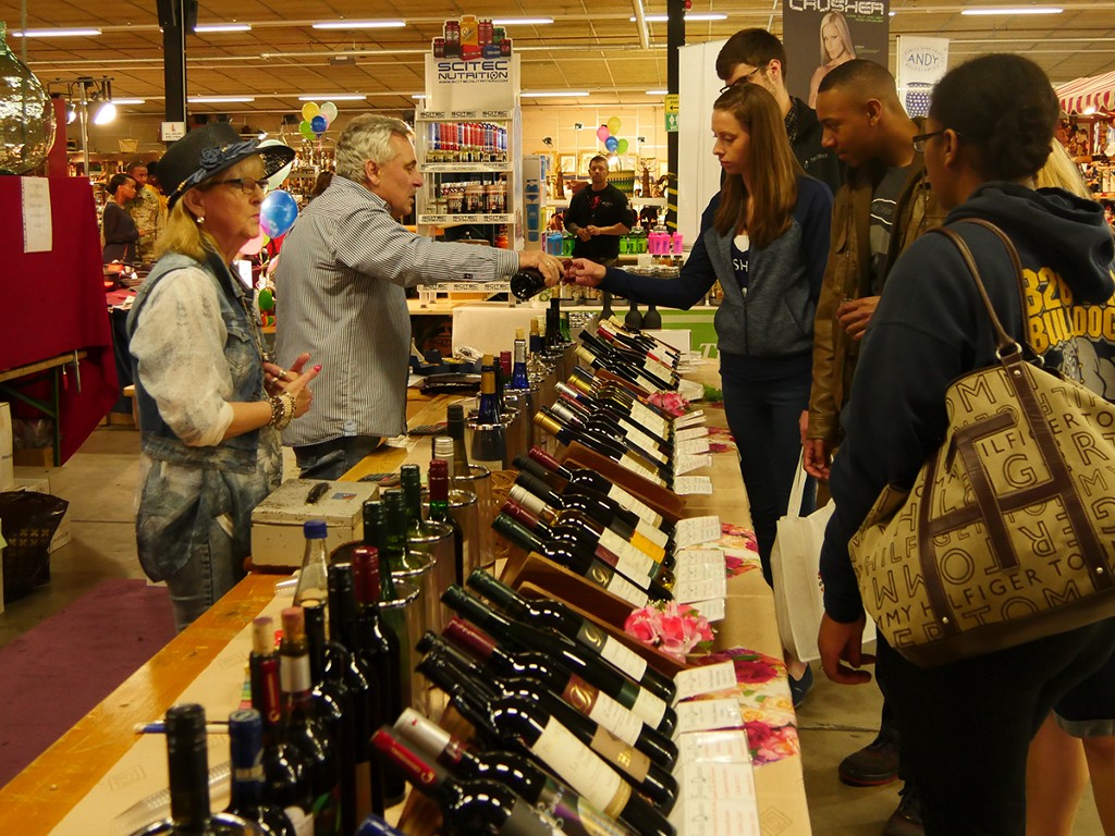 Shoppers sampling wine at a bazaar in Germany.