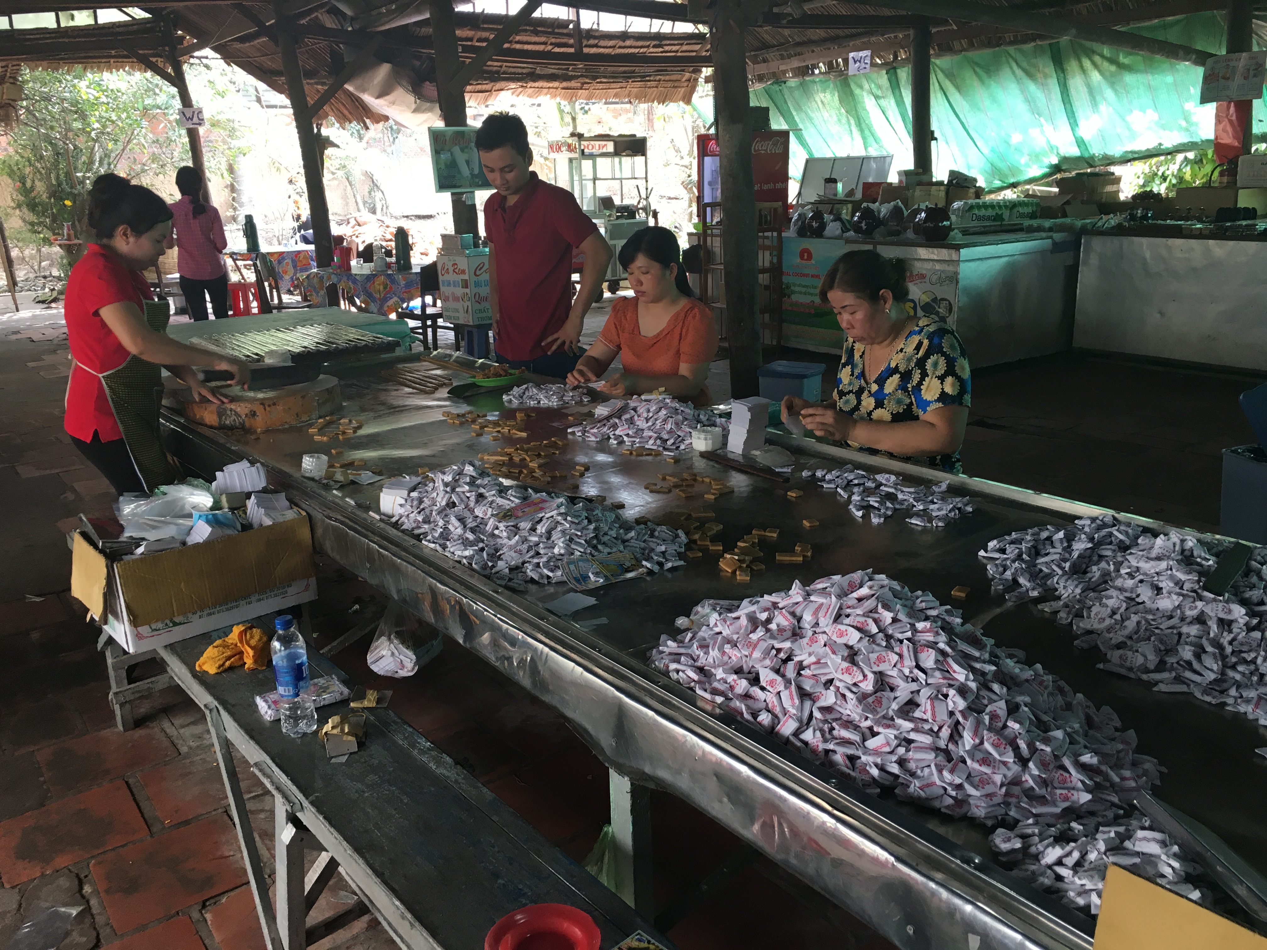 Local Vietnamese people making candy at the Mekong Delta.