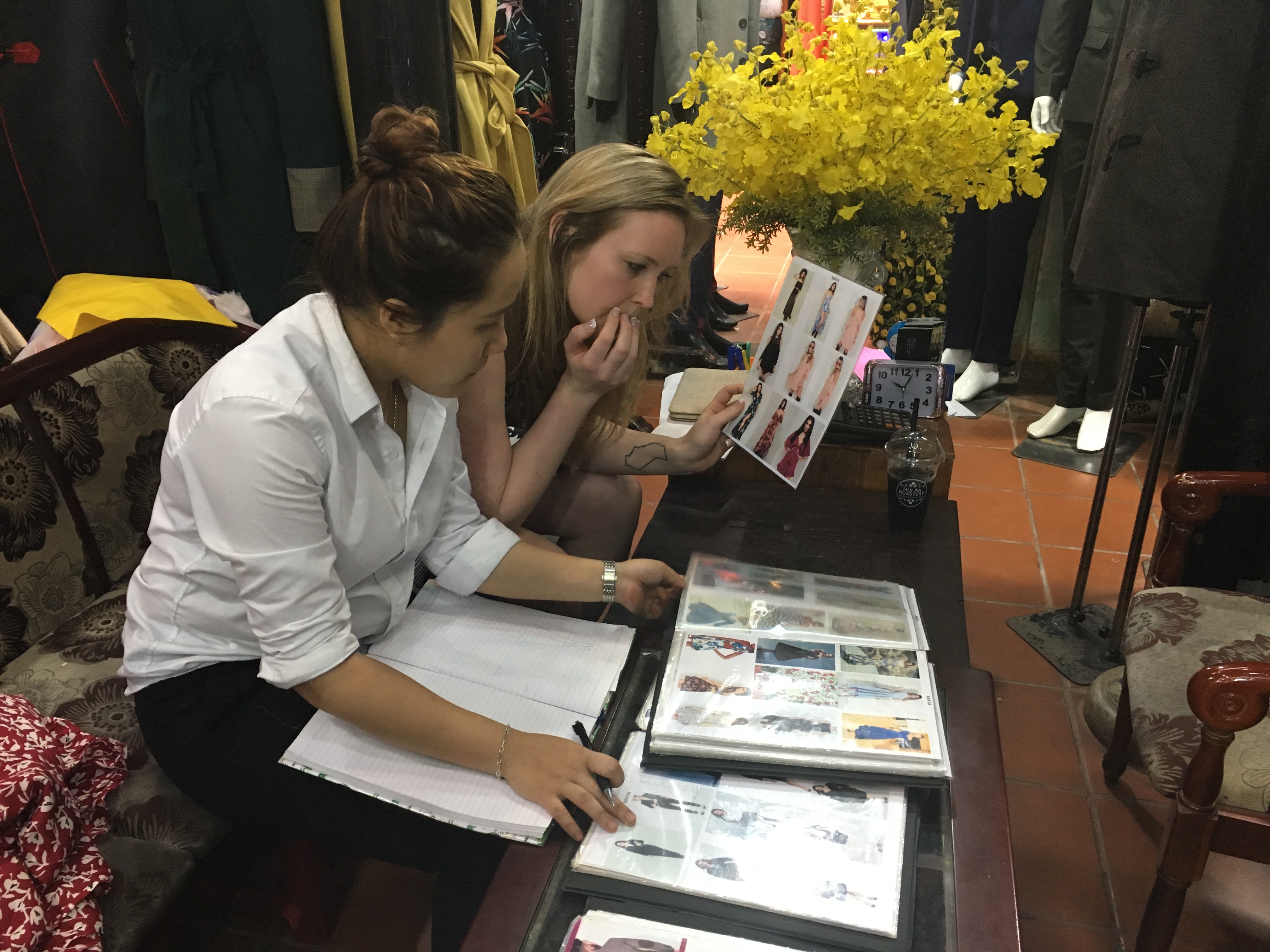 Erinn going over options for a custom-designed dress at a tailor shop in Hoi An, Vietnam.