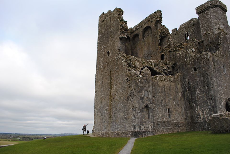 Erinn stands beside a monument at the Rock of Cashel.