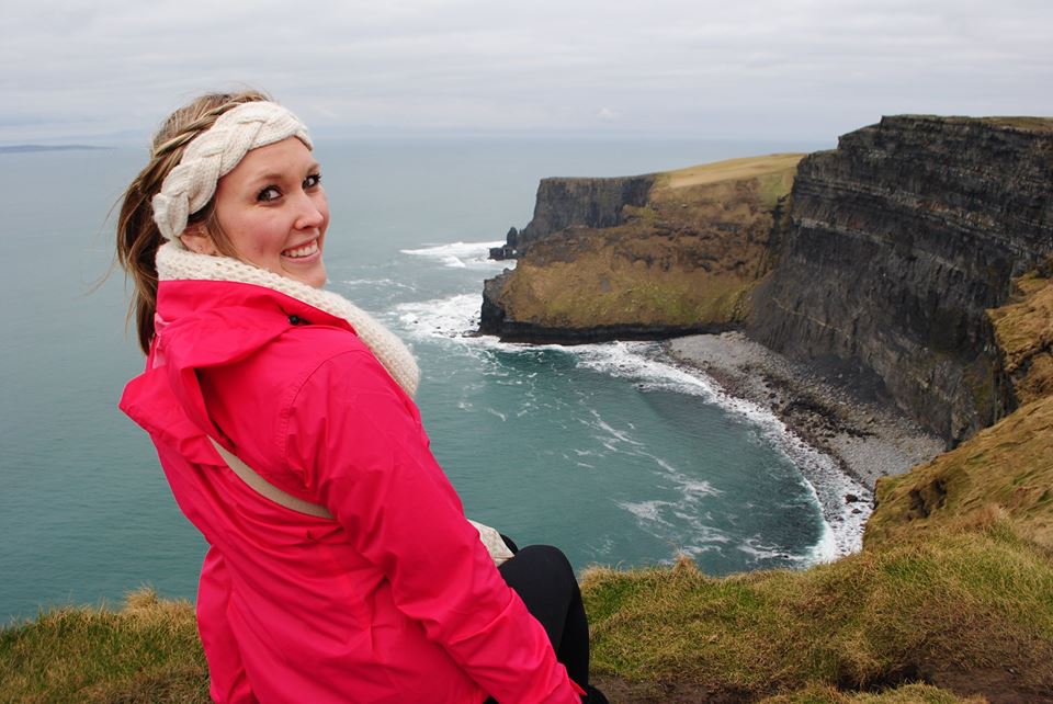 Erinn smiling at the Cliffs of Moher.