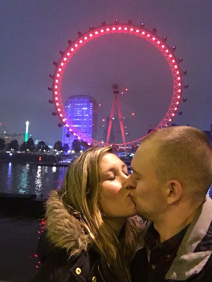 Erinn and Ben kissing in front of the London Eye.