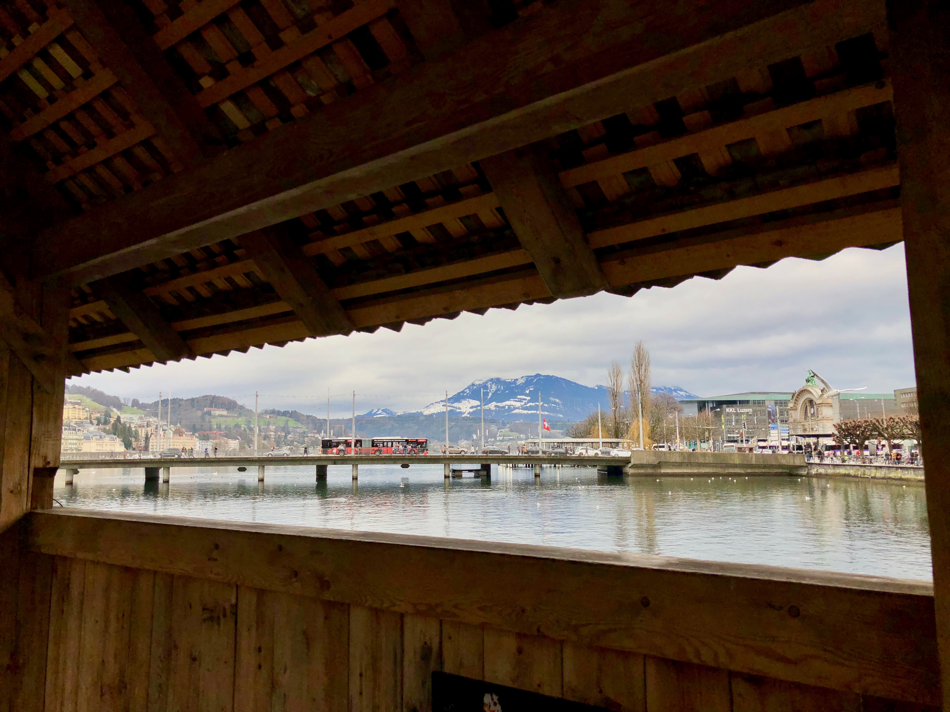 A picture taken from inside the Kapellbrücke, a wooden footbridge in Lucerne, Switzerland.