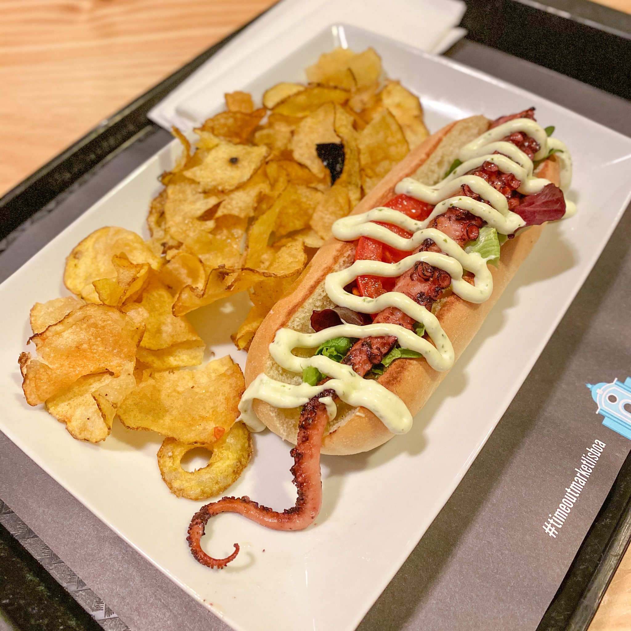 An octopus hot dog and chips from Time Out Market in Lisbon, Portugal.