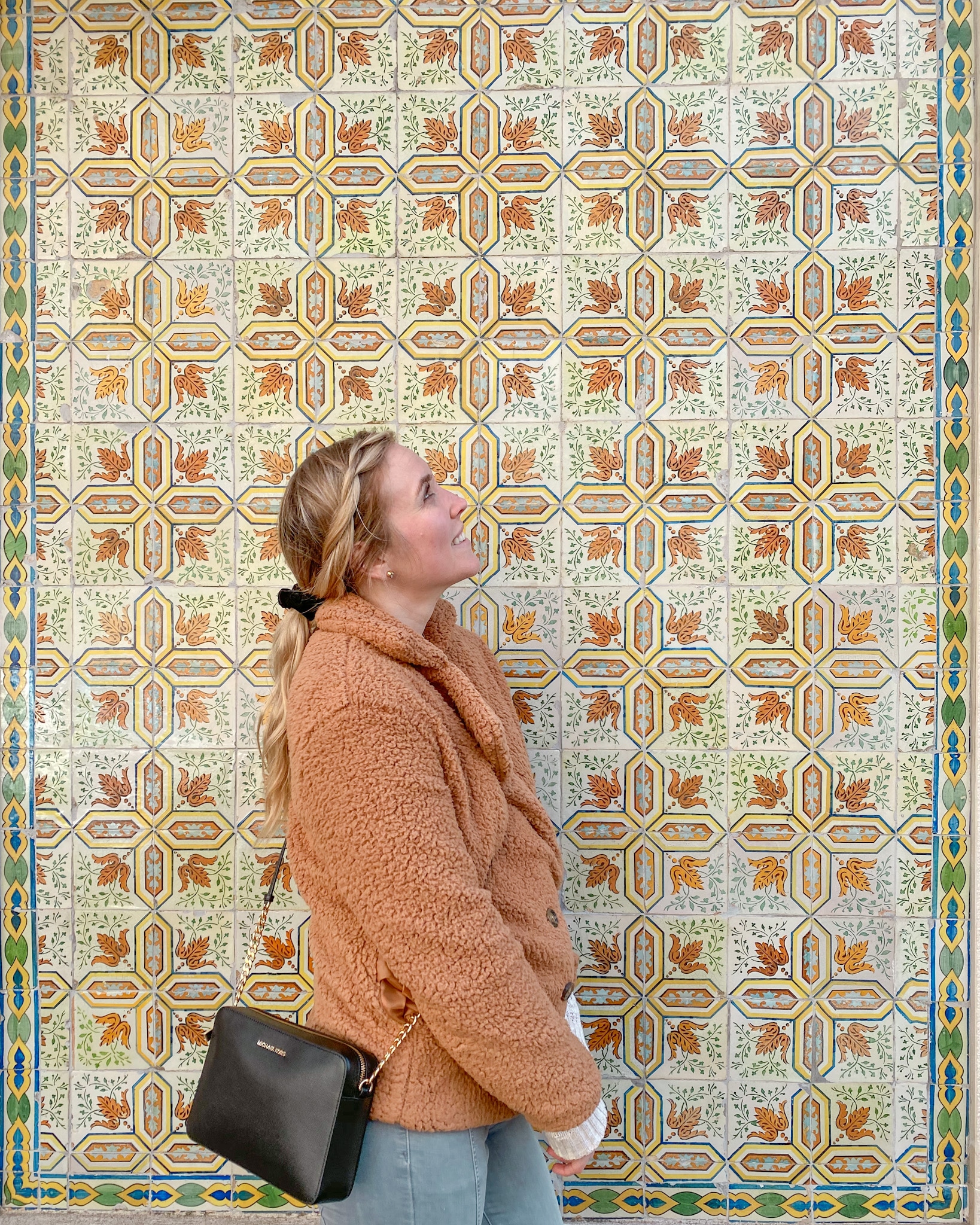 Erinn in front of azulejos (tiles) in Lisbon, Portugal.