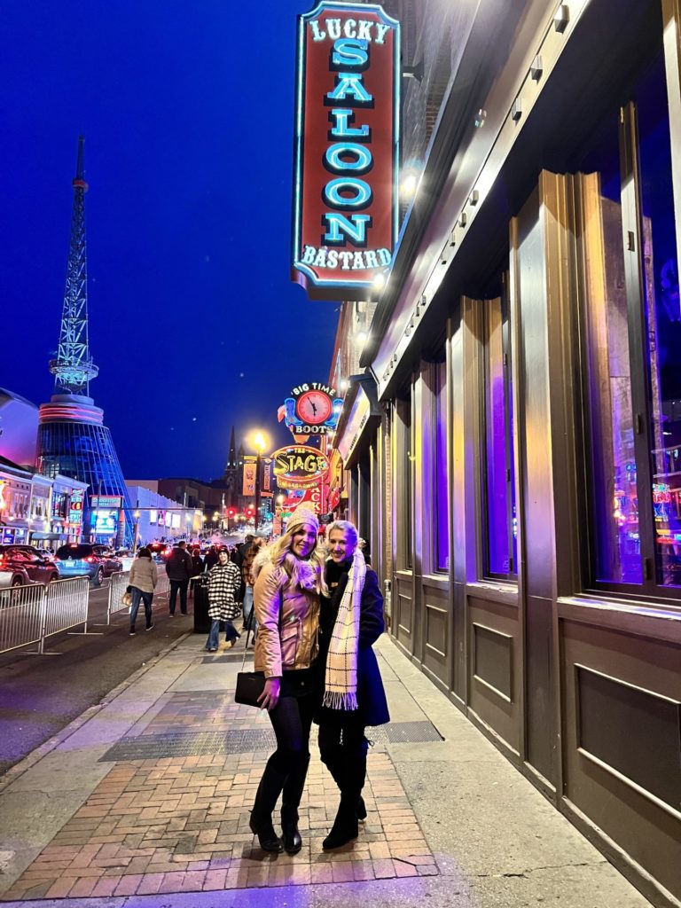 Erinn and Olivia smile for a picture on lower Broadway.