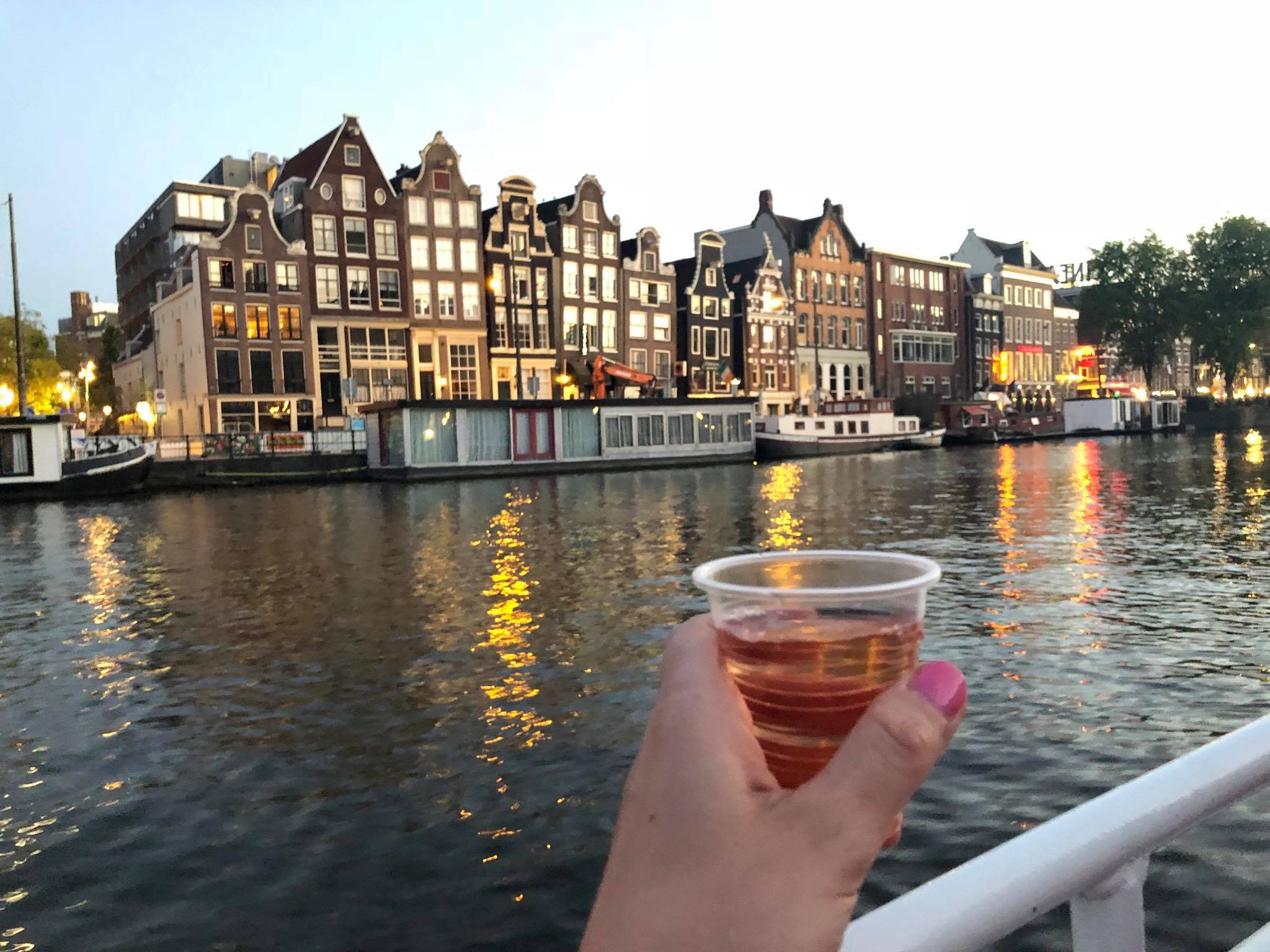 Drinking wine on a canal cruise in Amsterdam