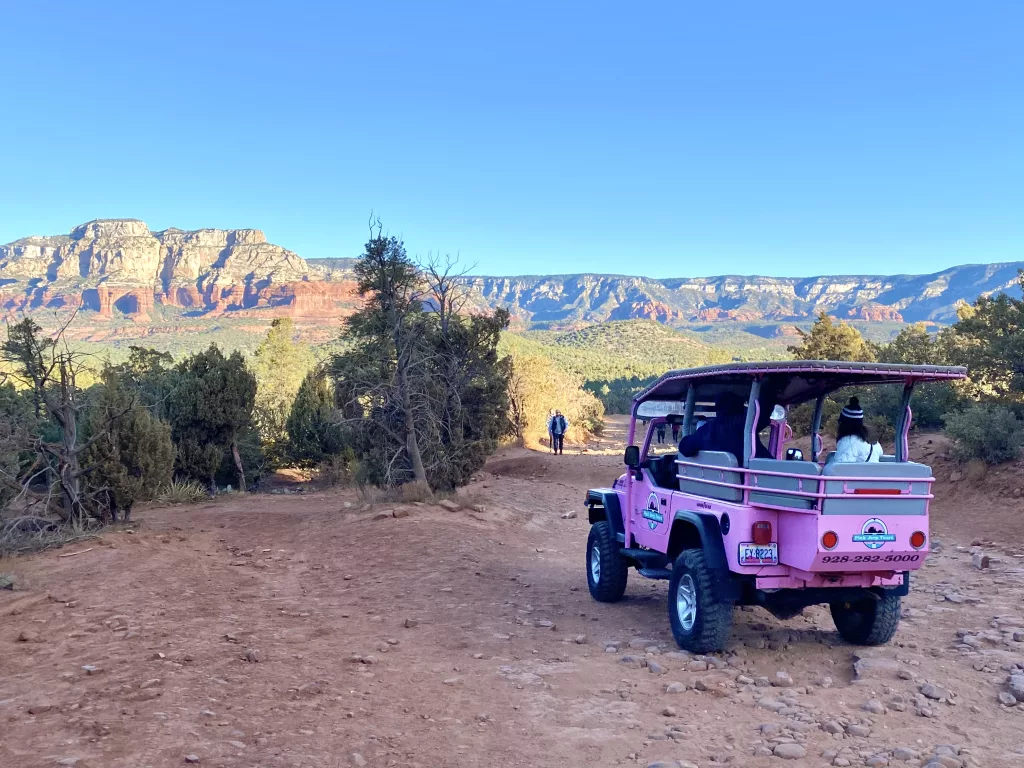 A pink Jeep driving along Dry Creek Road.