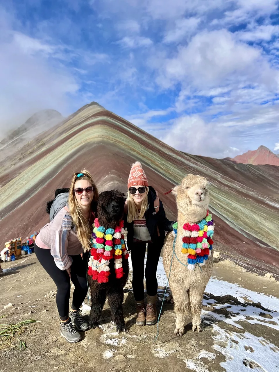 Erinn and Olivia with alpacas at Rainbow Mountain